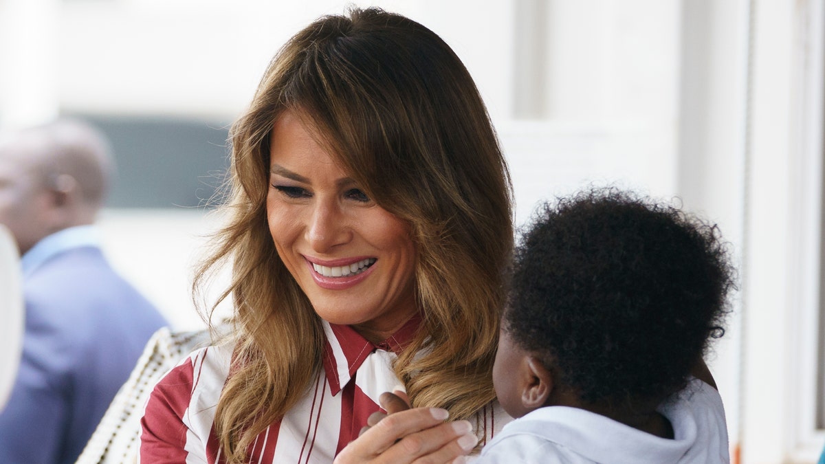 First lady Melania Trump holds a baby as she visits Greater Accra Regional Hospital in Accra, Ghana. 