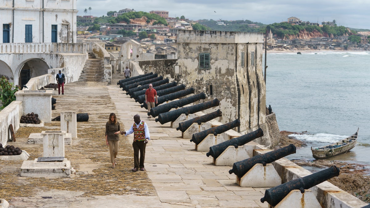 First lady Melania Trump tours Cape Coast Castle with museum educator Kwesi Essel-Blankson in Ghana on Oct. 3, 2018. The first lady is visiting Africa on her first solo international trip. (AP Photo/Carolyn Kaster)