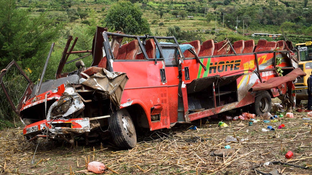 The wrecked bus is seen at the scene of a bus crash near Kericho in western Kenya Wednesday, Oct. 10, 2018. An official says at least 50 people have died after the bus they were traveling in left the road, rolled down a slope and crashed near the western Kenyan town of Kericho.