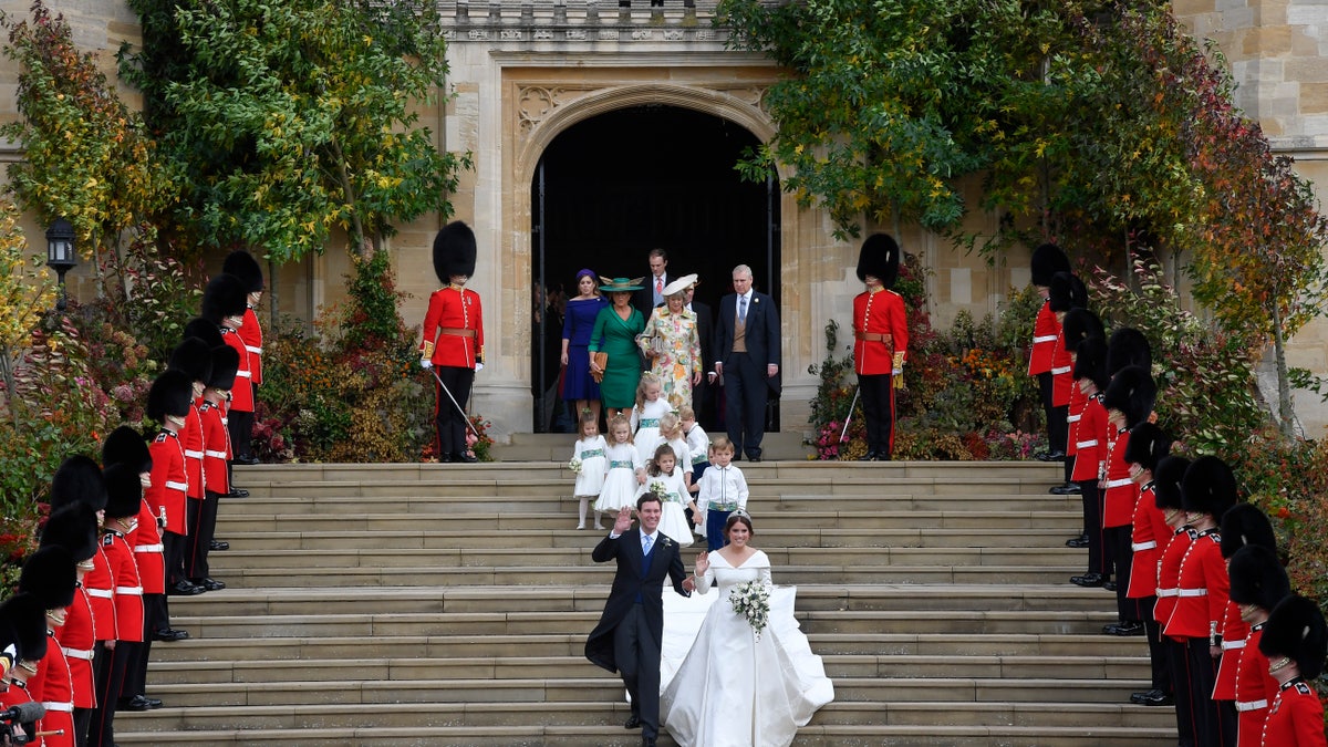 Britain's Princess Eugenie and Jack Brooksbank leave St George's Chapel after their wedding at Windsor Castle, near London, England, Friday Oct. 12, 2018. (Toby Melville, Pool via AP)