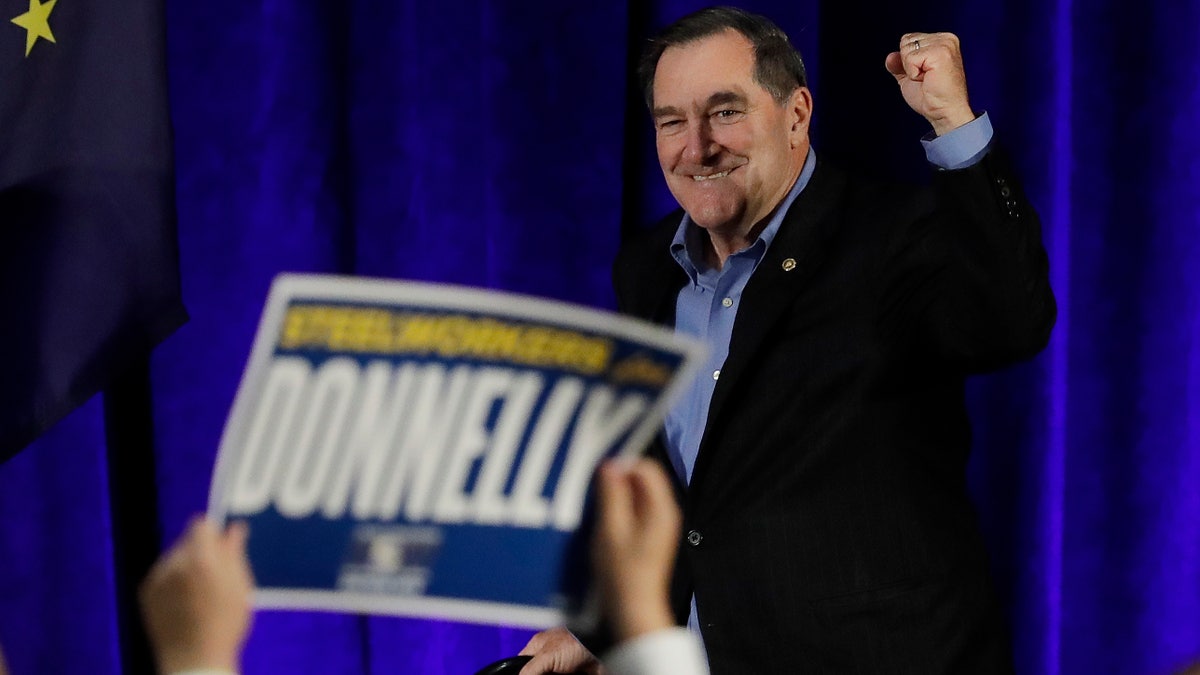 Democratic Sen. Joe Donnelly walks to the podium during a rally, Friday, Oct. 12, 2018, in Hammond, Ind.