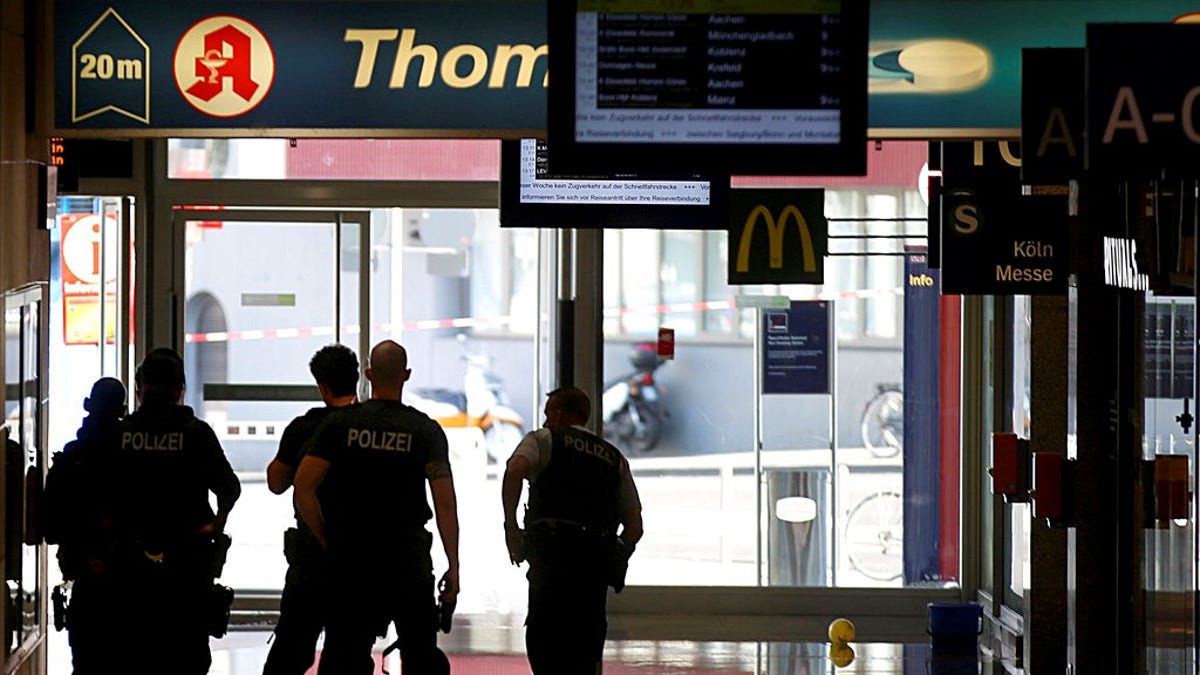 Police forces stand at the Cologne, western Germany, main station Monday, Oct. 15, 2018, after they have closed parts of the station because of a hostage situation. 