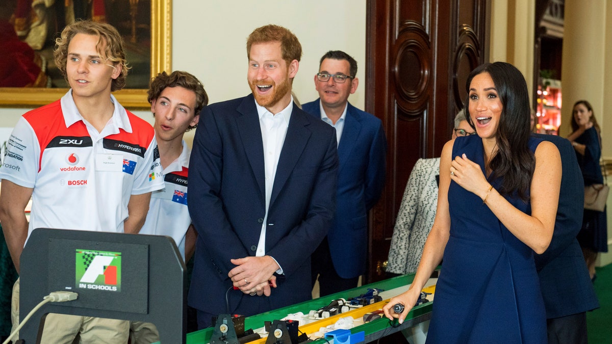 The Duke and Duchess of Sussex start model Formula 1 cars during a demonstration at a reception given by the Governor of Victoria at Government House during their visit to Melbourne, Australia, Thursday, Oct. 18, 2018. Prince Harry and his wife Meghan are on day two of their 16-day tour of Australia and the South Pacific. (Dominic Lipinski/Pool via AP)