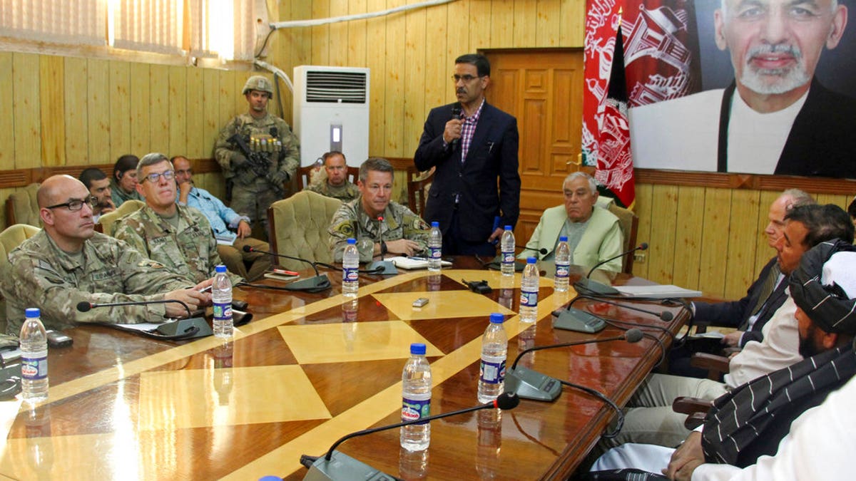 The head of NATO troops in Afghanistan, Gen. Scott Miller, center left, Kandahar Gov. Zalmay Wesa, center right, and their delegations attend a security conference, in Kandahar, Afghanistan, Thursday, Oct. 18, 2018.