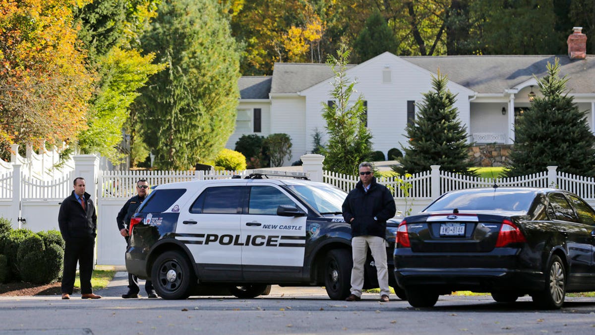 Police officers stand in front of property owned by Hillary and Bill Clinton in Chappaqua, N.Y., Wednesday, Oct. 24, 2018. A U.S. official says a "functional explosive device" was found at the Clinton's suburban New York home. (AP Photo/Seth Wenig)