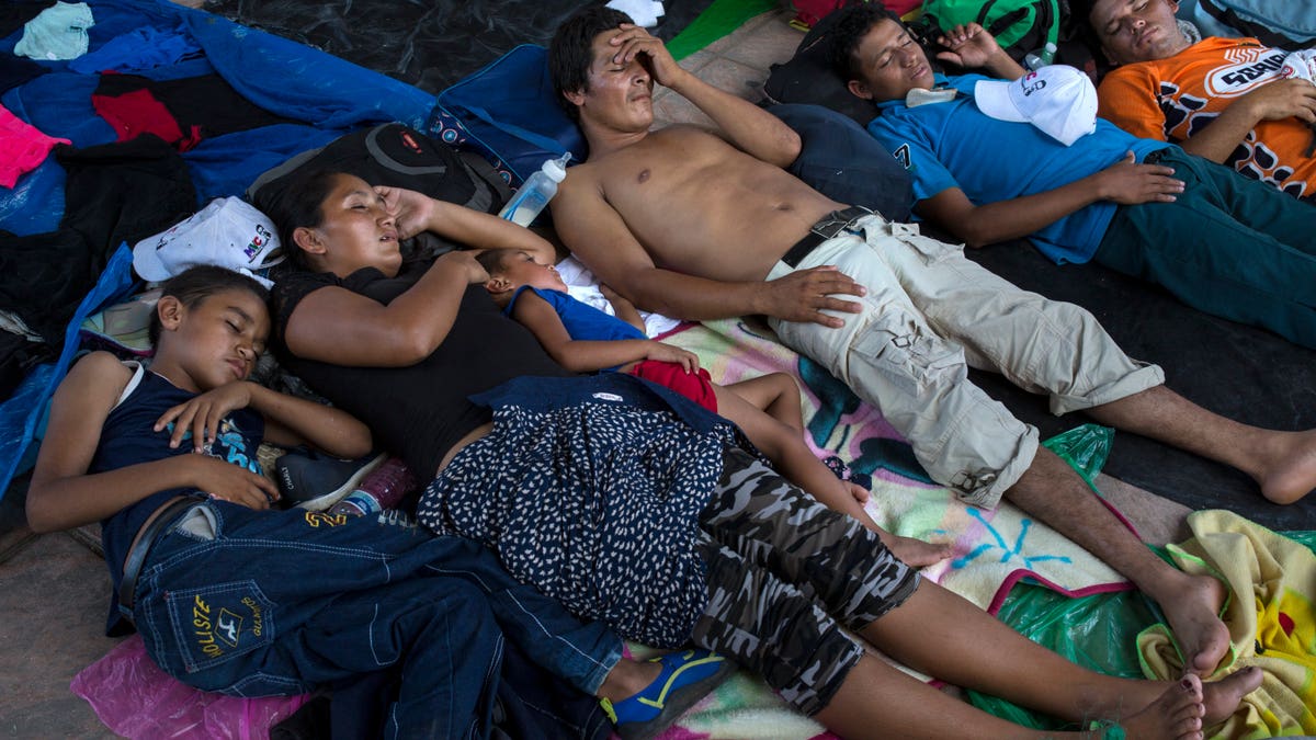 Honduran migrants rest in Pijijiapan, Mexico, Thursday, Oct. 25, 2018. Thousands of Central American migrants have renewed their hoped-for march to the United States on Wednesday. (AP Photo/Rodrigo Abd)