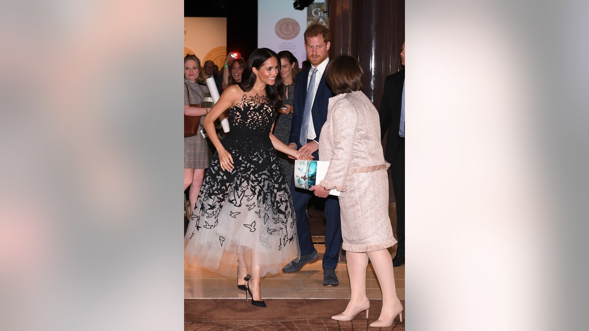 Britain's Prince Harry and his wife Meghan, the Duchess of Sussex arrive for the Australian Geographic Society Awards, in Sydney Friday, Oct. 26, 2018. (Joel Carrett/Pool Photo via AP)