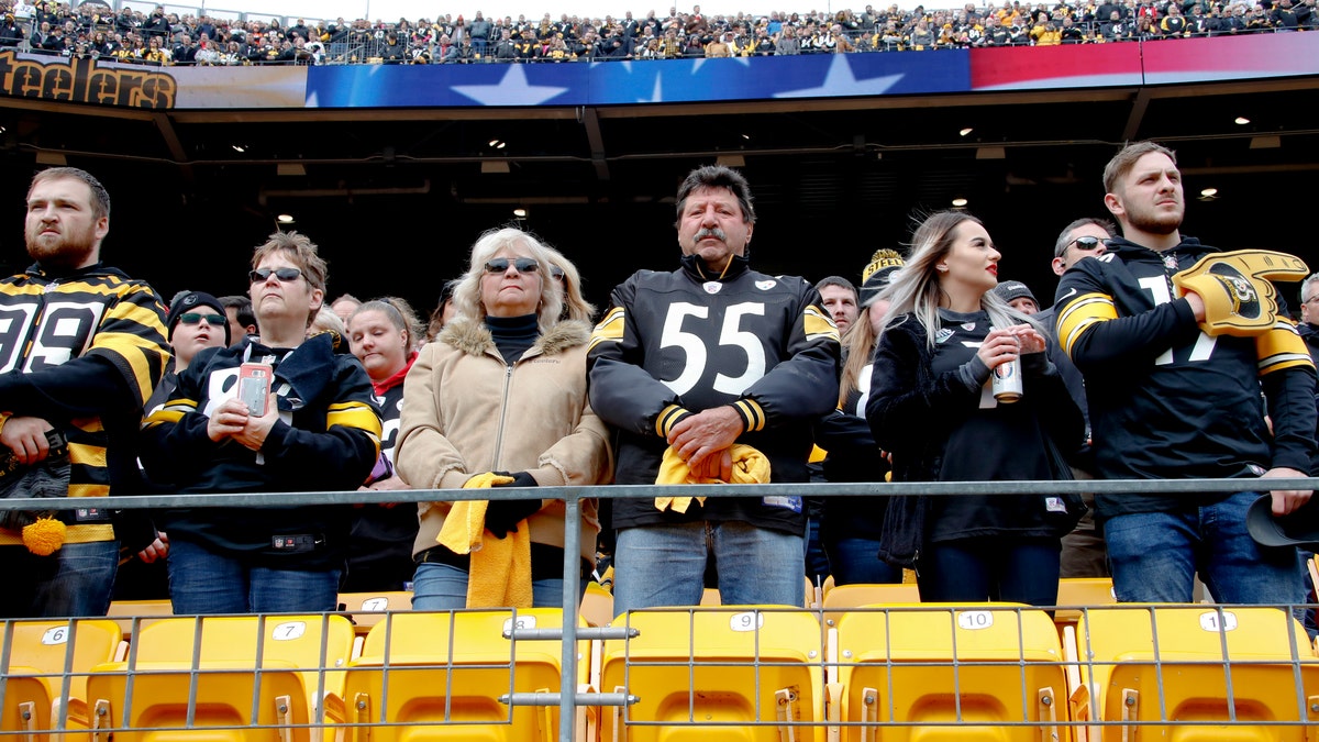 Pittsburgh Steelers fans stand for a moment of silence for the victims of a deadly shooting spree at a synagogue on Saturday before the start of an NFL football game against the Cleveland Browns, Sunday, Oct. 28, 2018, in Pittsburgh.