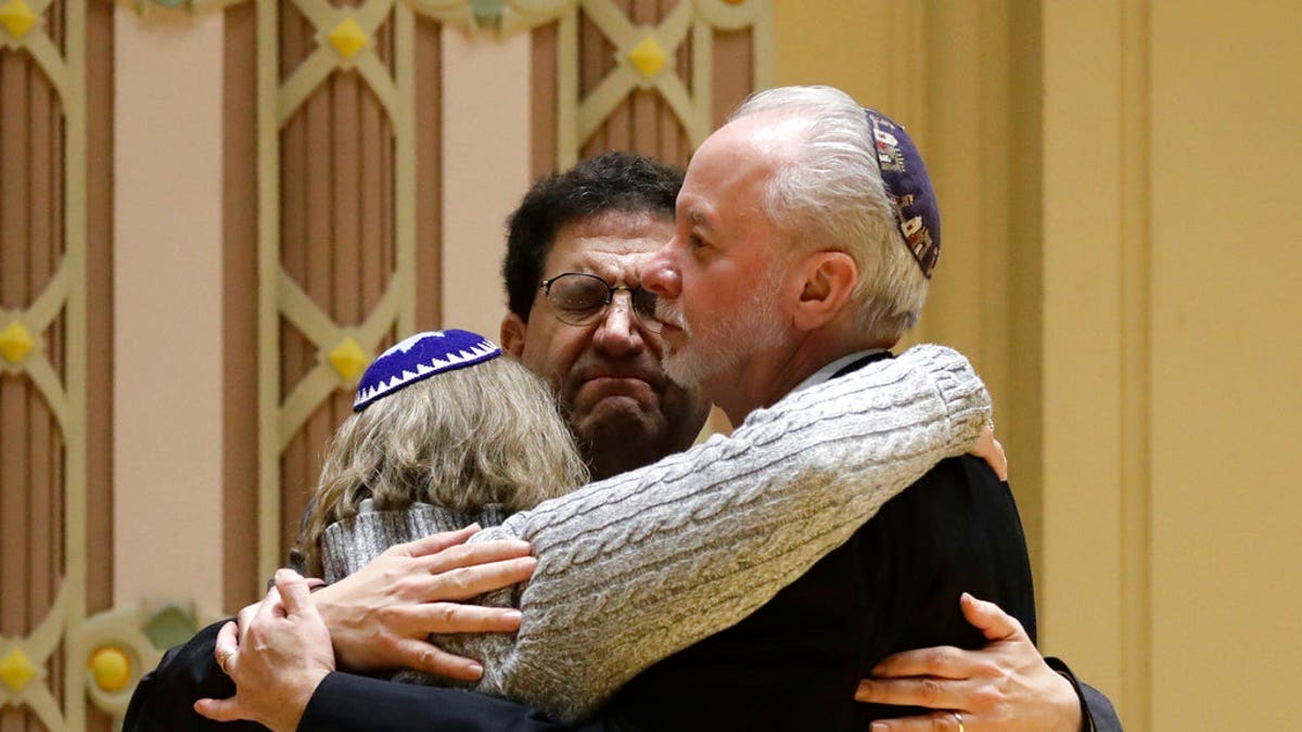Rabbi Jeffrey Myers, right, of Tree of Life/Or L'Simcha Congregation hugs Rabbi Cheryl Klein, left, of Dor Hadash Congregation and Rabbi Jonathan Perlman during a community gathering held in the aftermath of a deadly shooting at the Tree of Life Synagogue in Pittsburgh, Sunday, Oct. 28.