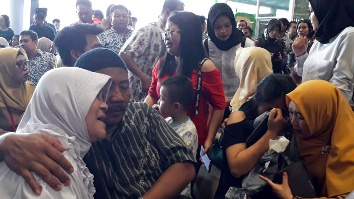 Relatives of passengers comfort each other as they wait for news on a Lion Air plane that crashed off Java Island at Depati Amir Airport in Pangkal Pinang, Indonesia.