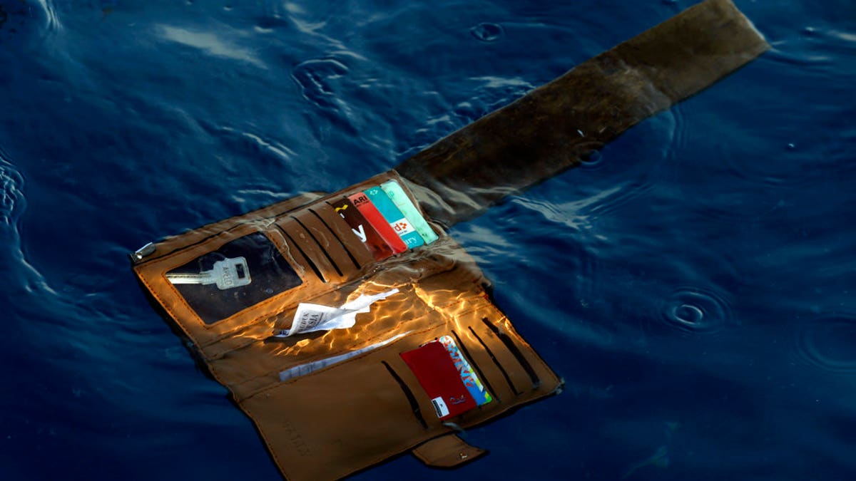 FILE: A wallet belonging to a victim of the Lion Air passenger jet that crashed is seen in the waters of Ujung Karawang, West Java, Indonesia.
