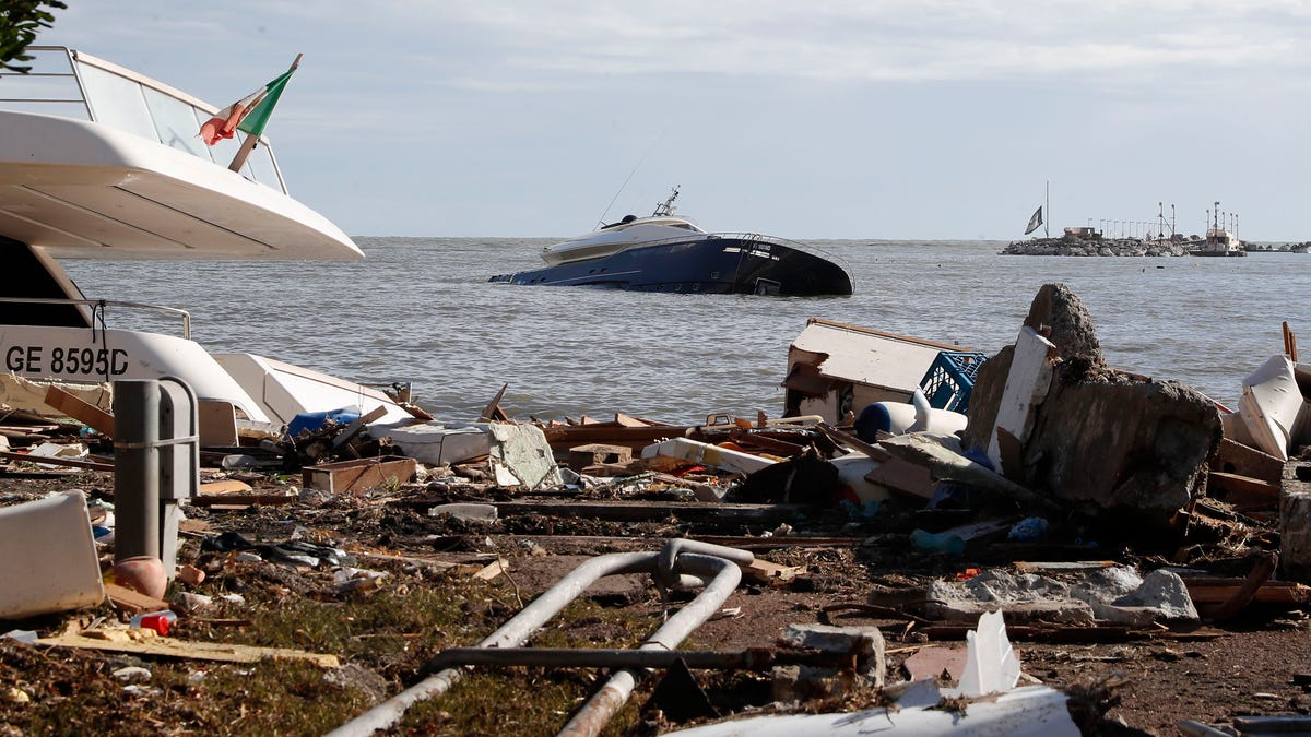 A partially sunken boat is seen at sea a day after a storm washed up several boats, in Rapallo, northern Italy, Tuesday, Oct. 30, 2018. (AP Photo/Antonio Calanni)