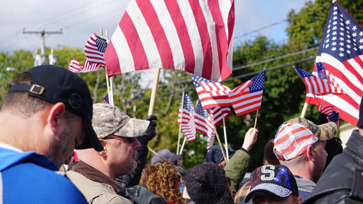 Supporters wave flags at the "American flag appreciation walk" in New Paltz, New York Sunday afternoon.