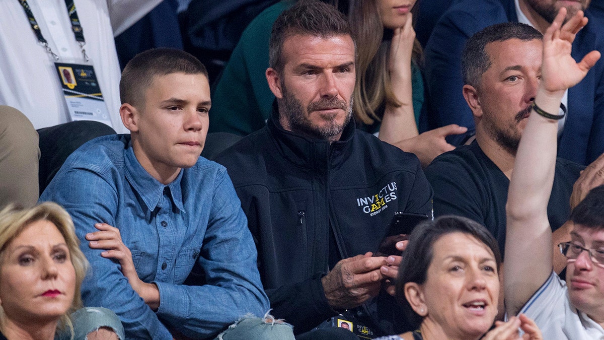 Former England footballer David Beckham and his son Romeo watch the wheelchair basketball final at The Invictus Games in Sydney, Australia, Saturday, Oct. 27, 2018. Prince Harry and his wife Meghan are on day twelve of their 16-day tour of Australia and the South Pacific. (AP Photo)