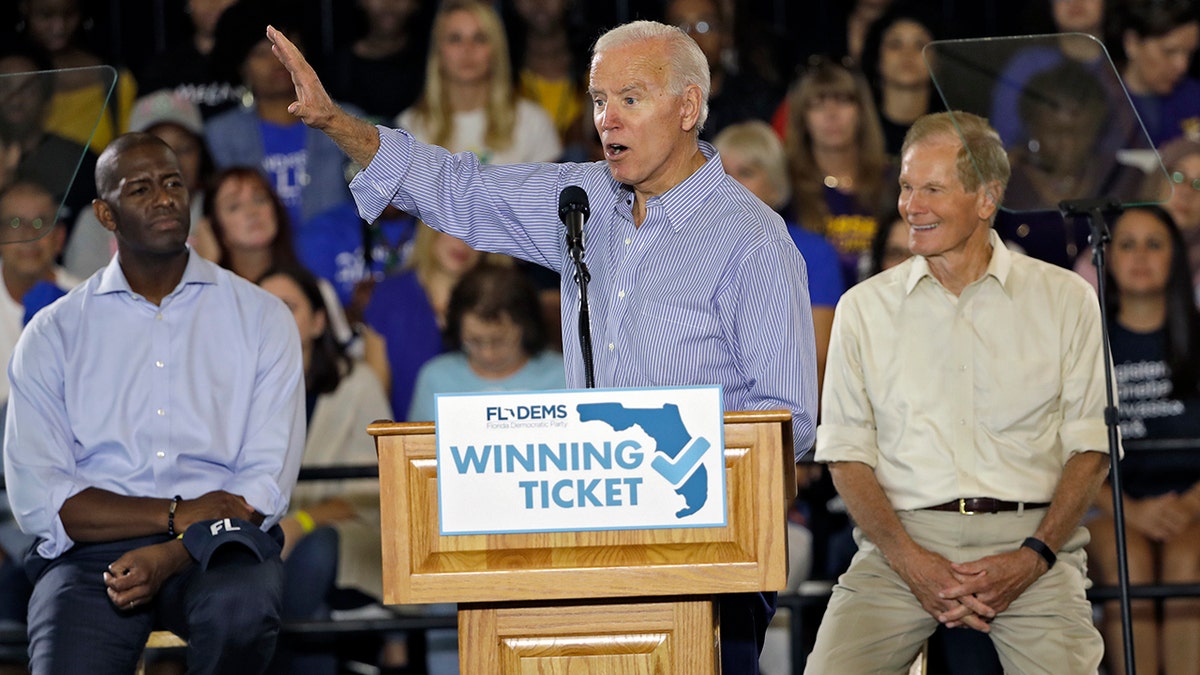 Former Vice President Joe Biden gestures as Florida Democratic gubernatorial candidate Andrew Gillum, left, and U.S. Sen. Bill Nelson, D-Fla., right, look on during a campaign rally for Gillum and Nelson on Monday in Tampa, Fla. (AP Photo/Chris O'Meara)