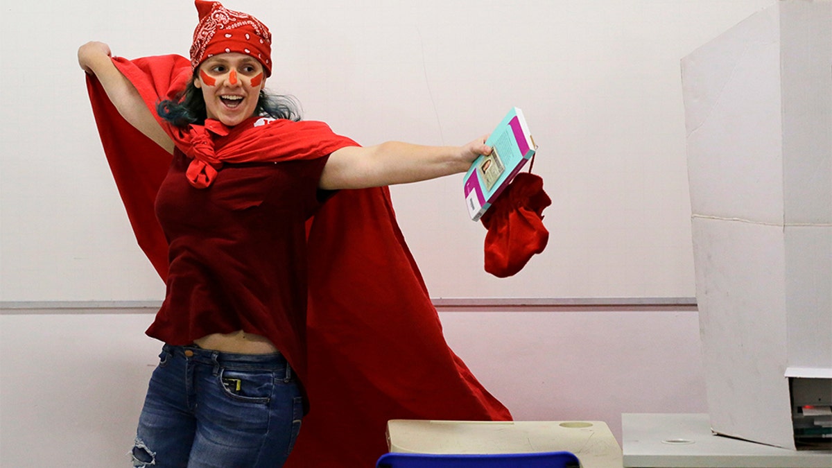 A woman donning the official Workers' Party color celebrates after voting in the presidential runoff election in Sao Paulo, Brazil, on Sunday. (AP Photo/Nelson Antoine)