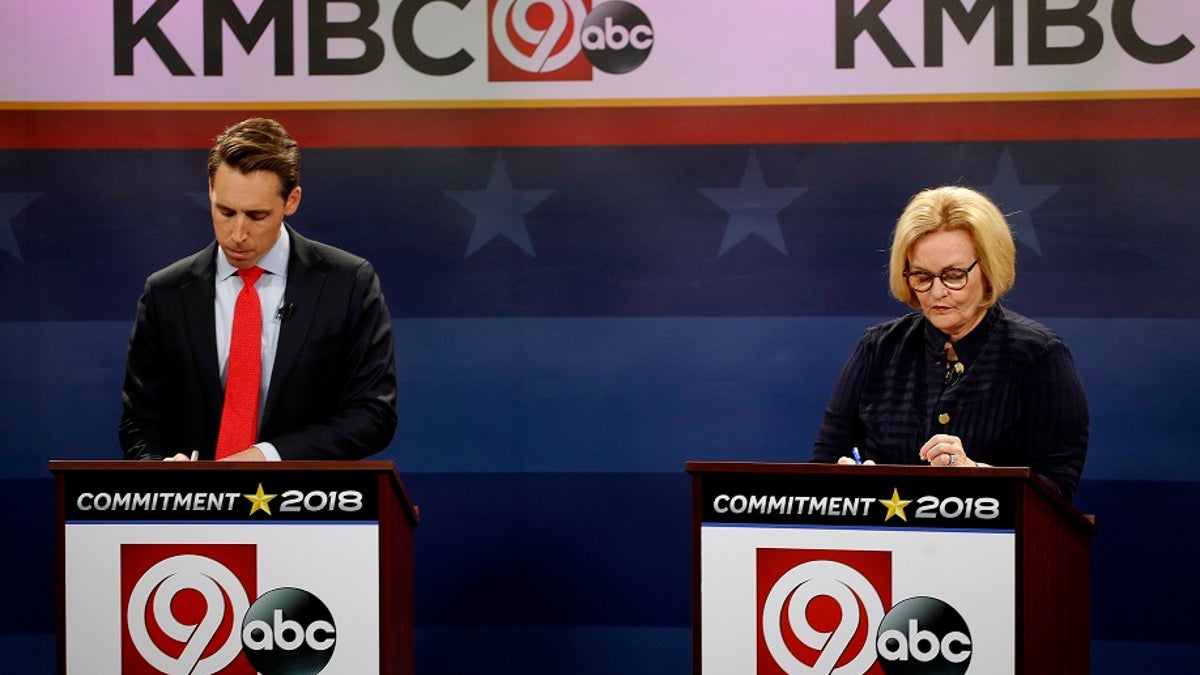 FILE - Missouri U.S. Senate candidates incumbent Democratic Sen. Claire McCaskill, right, and Republican challenger Josh Hawley look over their notes before the start of a debate.