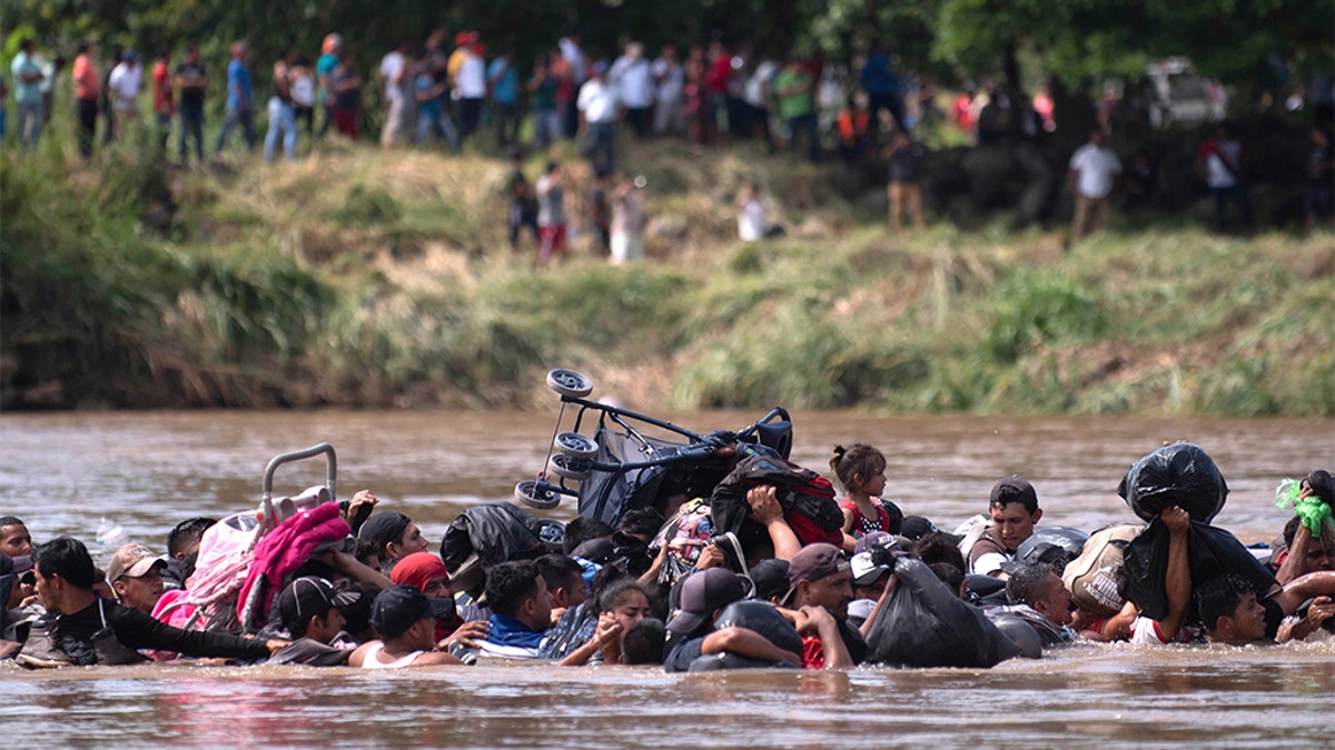 A group of Central American migrants wading across the Suchiate River. (AP Photo/Santiago Billy)