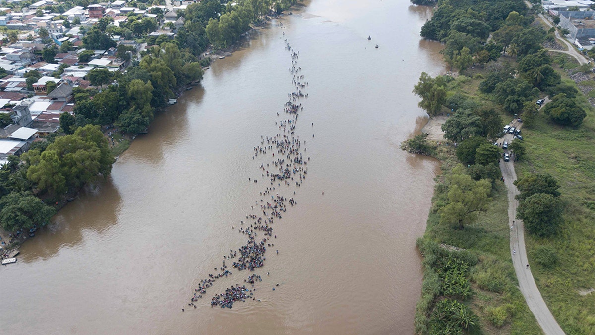 A new group of Central American migrants bound for the U.S border, wading across the Suchiate River, that connects Guatemala and Mexico, in Tecun Uman, Guatemala. (AP Photo/Santiago Billy)