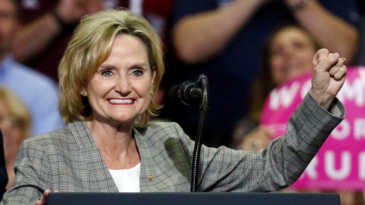 FILE - In this Oct. 2, 2018 photograph, U.S. Sen. Cindy Hyde-Smith, R-Miss., encourages the crowd at a rally in Southaven, Miss. (AP Photo/Rogelio V. Solis, File)
