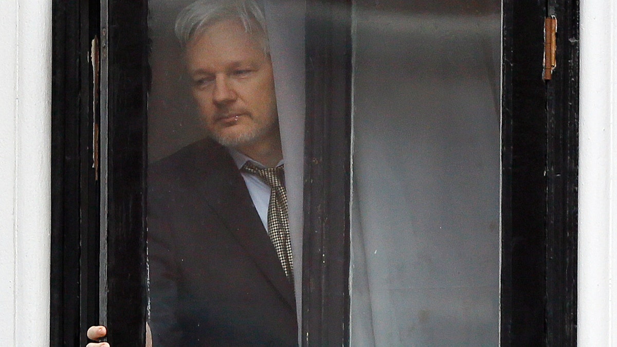 FILE - In this Feb. 5, 2016 file photo, Wikileaks founder Julian Assange walks onto the balcony of the Ecuadorean Embassy in London. An Ecuadorean judge ruled Monday, Oct. 29, 2018 against a request by him to loosen requirements he says are meant to push him out of the London embassy where he lives. (AP Photo/Kirsty Wigglesworth, File)