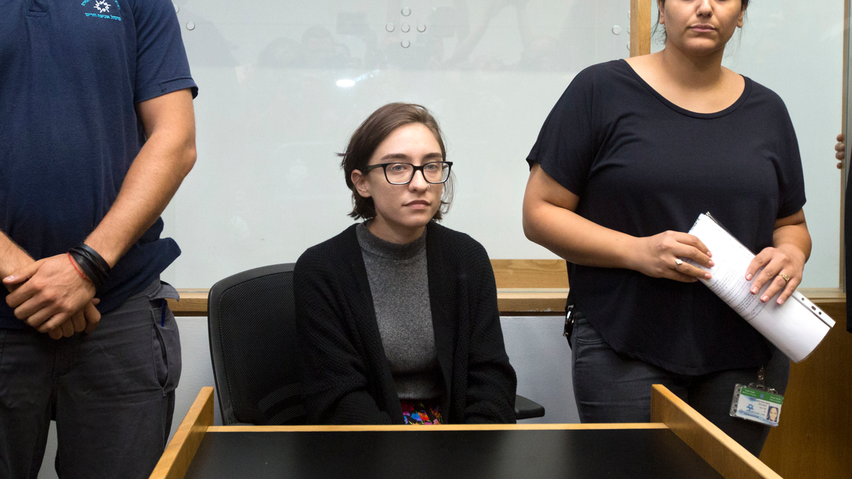 Lawyers for Lara Alqasem, center, who was denied entry to Israel because of alleged support for a boycott campaign, say the Supreme Court has accepted her appeal and will allow her study at Hebrew University, where she had been registered for classes. (AP Photo/Sebastian Scheiner)