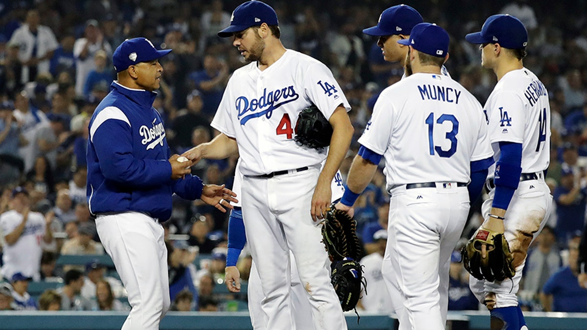 Los Angeles Dodgers pitcher Rich Hill is relieved by Los Angeles Dodgers manager Dave Roberts during the seventh inning in Game 4 of the World Series baseball game on Saturday, Oct. 27, 2018, in Los Angeles. (AP Photo/David J. Phillip)