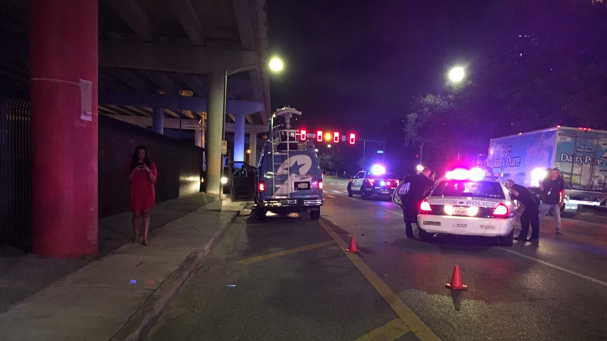 Police are hunting for a man who stole a police cruiser after slamming into a Texas TV crew's van.