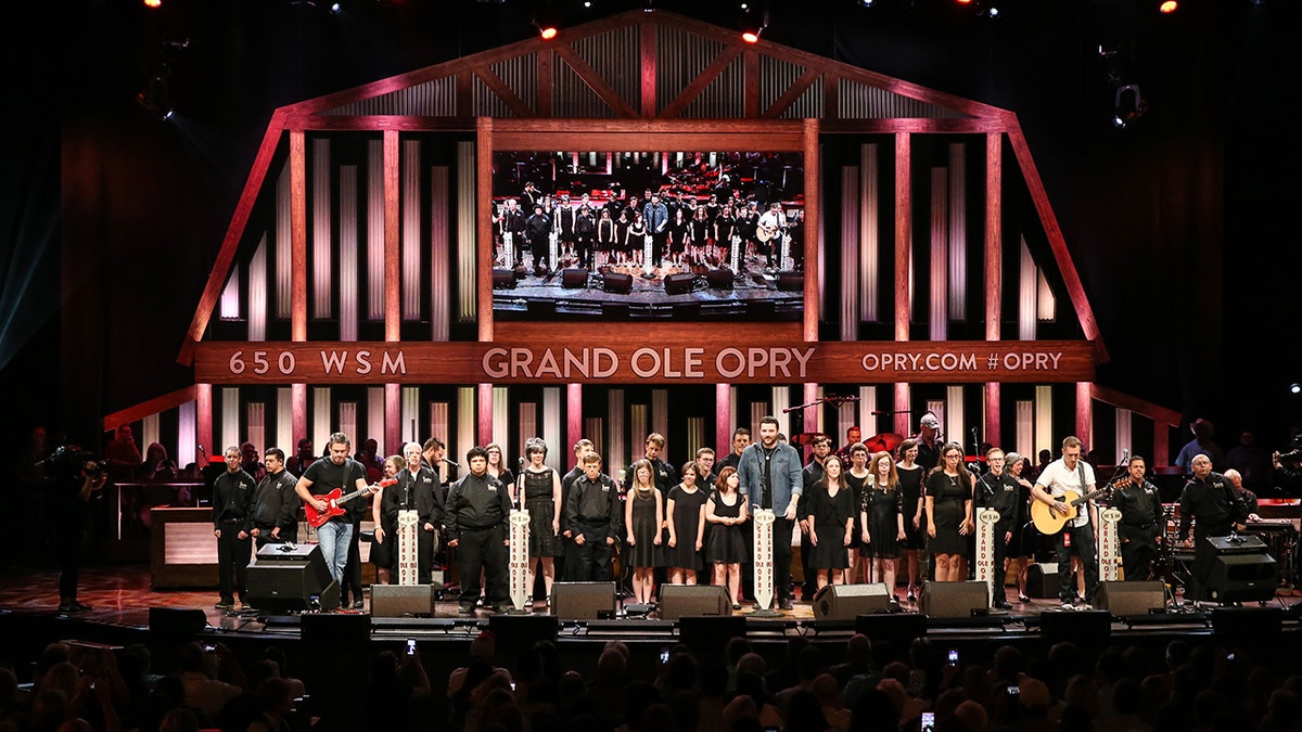 The Grand Ole Opry will help raise money for a fan battling cancer. Pictured is the ACM Lifting Lives music Campers joining Singer-songwriter Chris Young on stage during a Performance at Grand Ole Opry House on June 27, 2017 in Nashville, Tennessee.