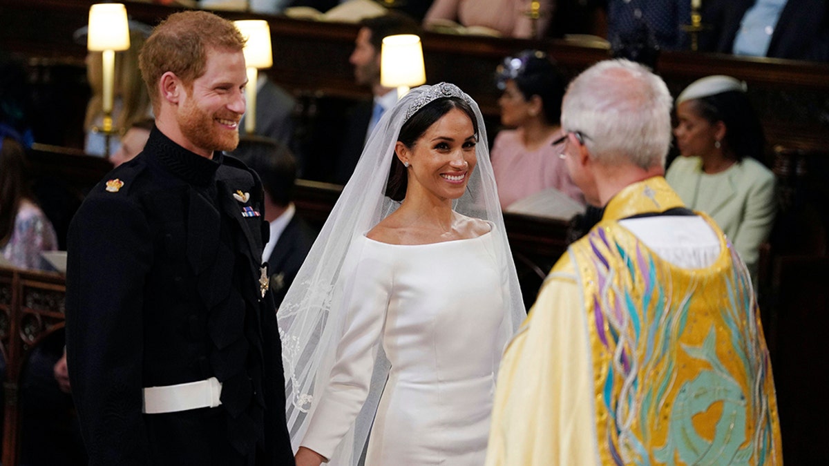 Prince Harry and Meghan Markle during their wedding service at St. George's Chapel in Windsor Castle in Windsor, near London, England, Saturday, May 19, 2018. AP