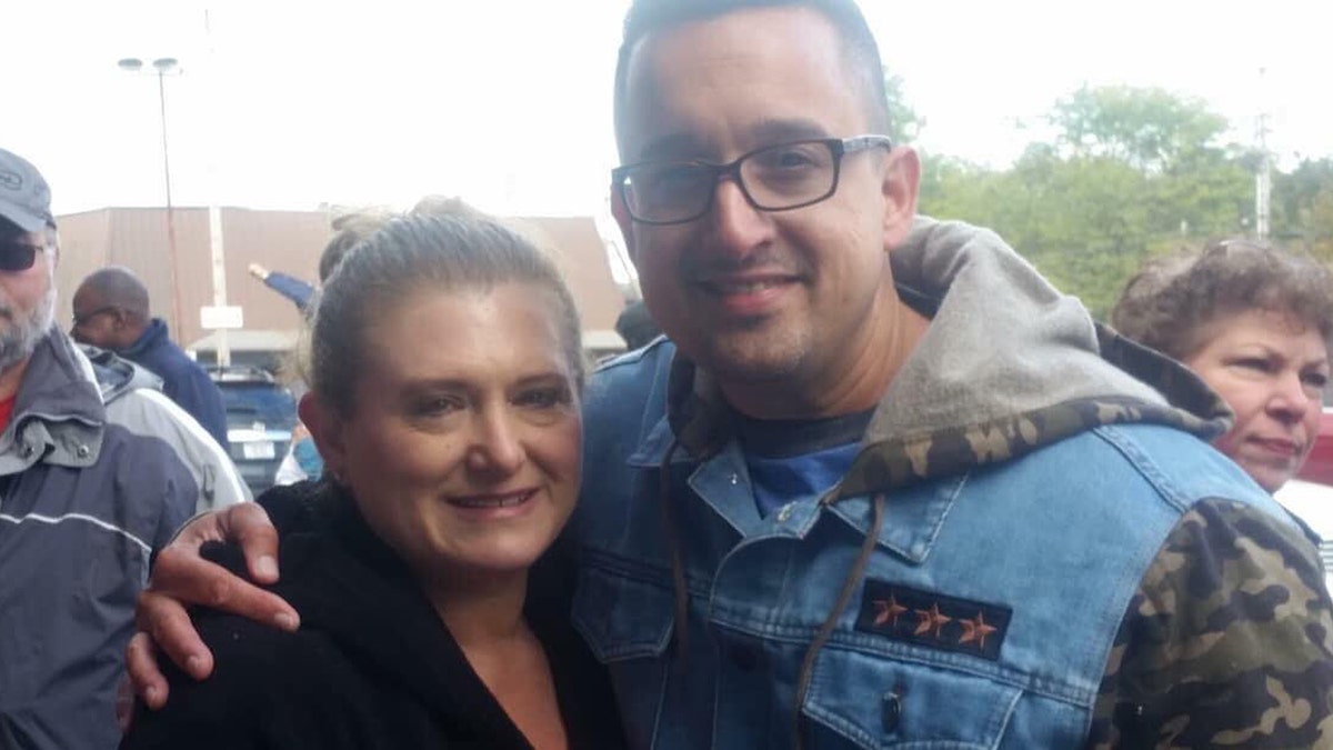 Maria Lisante, the owner of La Bella Pizza Bistro in New Paltz, New York, with her friend, Joey Garcia, a New York state corrections officers and veteran, who organized the "American flag appreciation walk" Sunday in support of the American flag mural at her business.