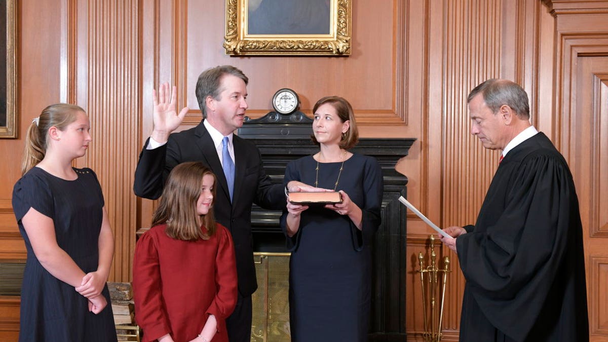 Chief Justice John Roberts, right, administers the Constitutional Oath to Judge Brett Kavanaugh in the Justices' Conference Room of the Supreme Court Building. (Fred Schilling/Collection of the Supreme Court of the United States via AP)