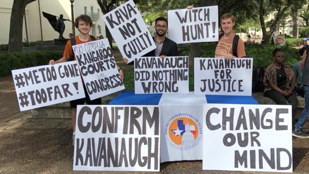 The Young Conservatives of Texas at the University of Texas, Austin hold up their signs before liberal students starting ripping up their signs and shouting expletives at them.