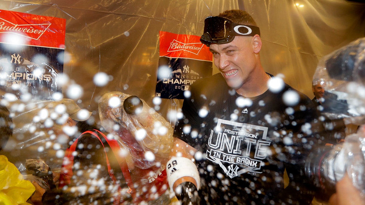 ​​​​​New York Yankees' Aaron Judge celebrates in the locker room after the Yankees beat the Oakland Athletics 7-2 in the American League wild-card playoff baseball game.