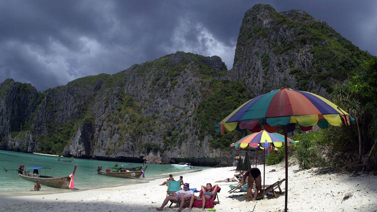 Tourists catch the sun's rays on remote Maya Bay in southern Thailand, made famous as the shooting location of the Leonardo DiCaprio movie, "The Beach."
