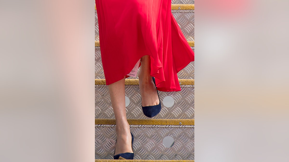 A label hanging from the dress worn by the Duchess of Sussex, as she arrives at Fua'amotu Airport, Tonga, Thursday, Oct. 25, 2018. Prince Harry and his wife Meghan are on day 10 of their 16-day tour of Australia and the South Pacific. (Dominic Lipinski/Pool Photo via AP)