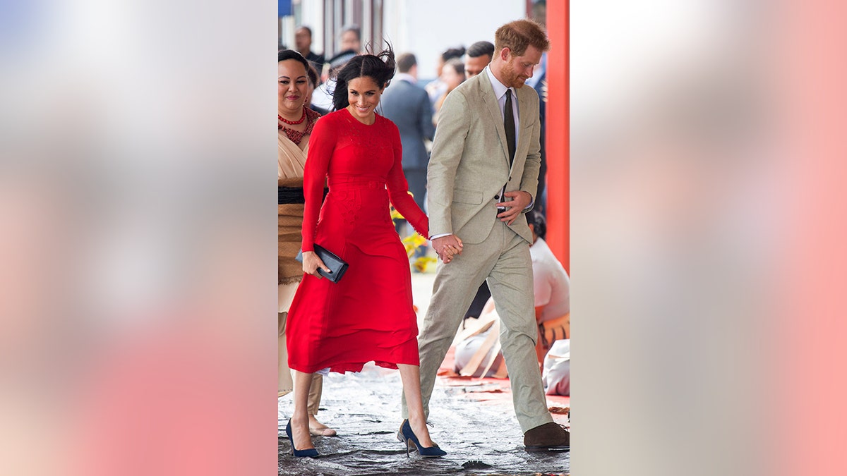 Britain's Prince Harry and Meghan, Duchess of Sussex arrive at Fua'amotu Airport in Tonga, Thursday, Oct. 25, 2018. Prince Harry and his wife Meghan are on day 10 of their 16-day tour of Australia and the South Pacific. (Dominic Lipinski/Pool Photo via AP)