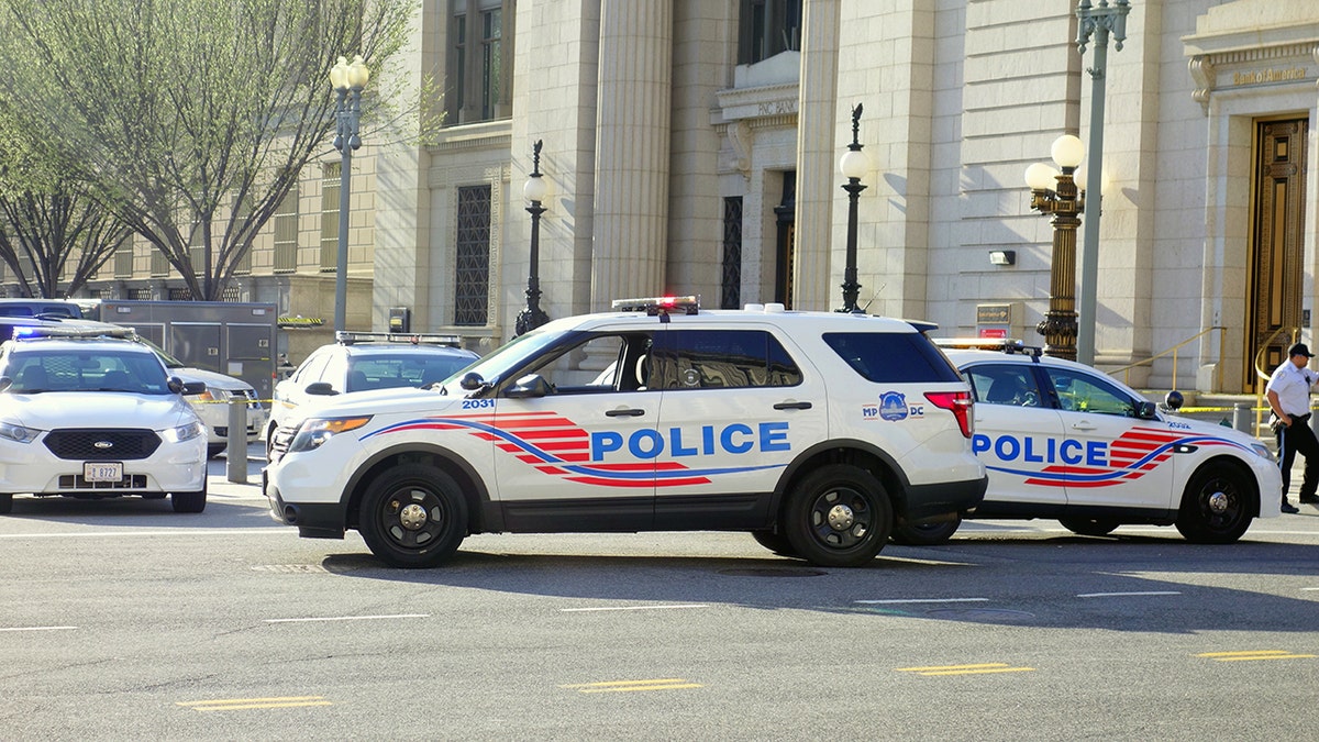Washington DC, USA - April 12, 2015: Police vehicles stopping the traffic and closing a street in Washington, D.C.