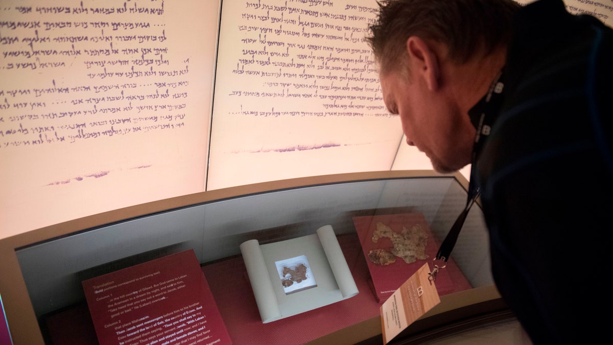 File photo - a visitor looks at an exhibit about the Dead Sea scrolls at the Museum of the Bible, a museum dedicated to the history, narrative and impact of the Bible, in Washington, DC, Nov. 14, 2017. (SAUL LOEB/AFP/Getty Images)