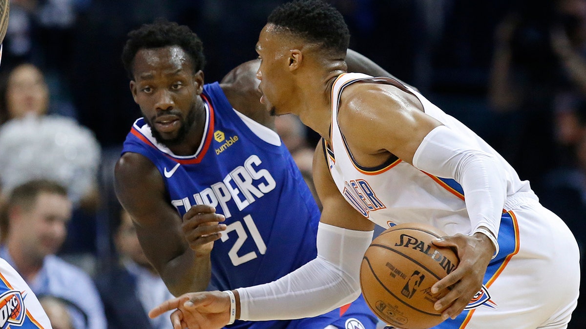 Oklahoma City Thunder guard Russell Westbrook, right, drives around Los Angeles Clippers guard Patrick Beverley (21) in the first half of an NBA basketball game in Oklahoma City, Tuesday, Oct. 30, 2018.