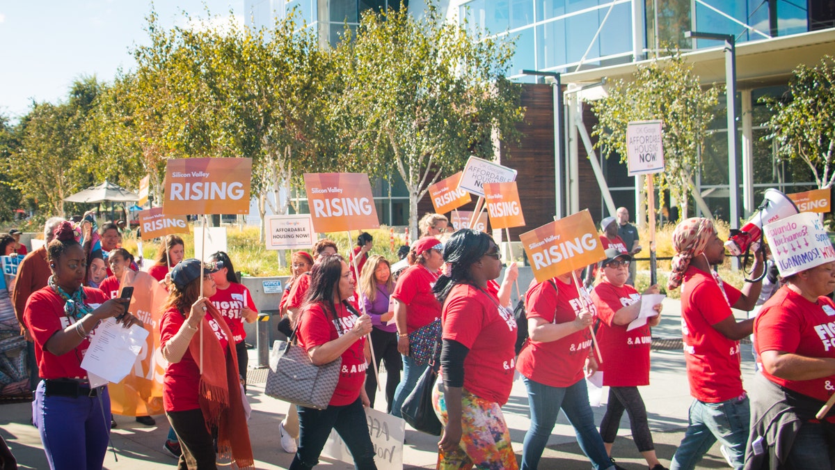 Activists from Silicon Valley Rising march on Google's campus in Mountain View, California