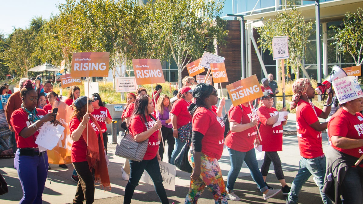 Activists from Silicon Valley Rising march on Google's campus in Mountain View, California