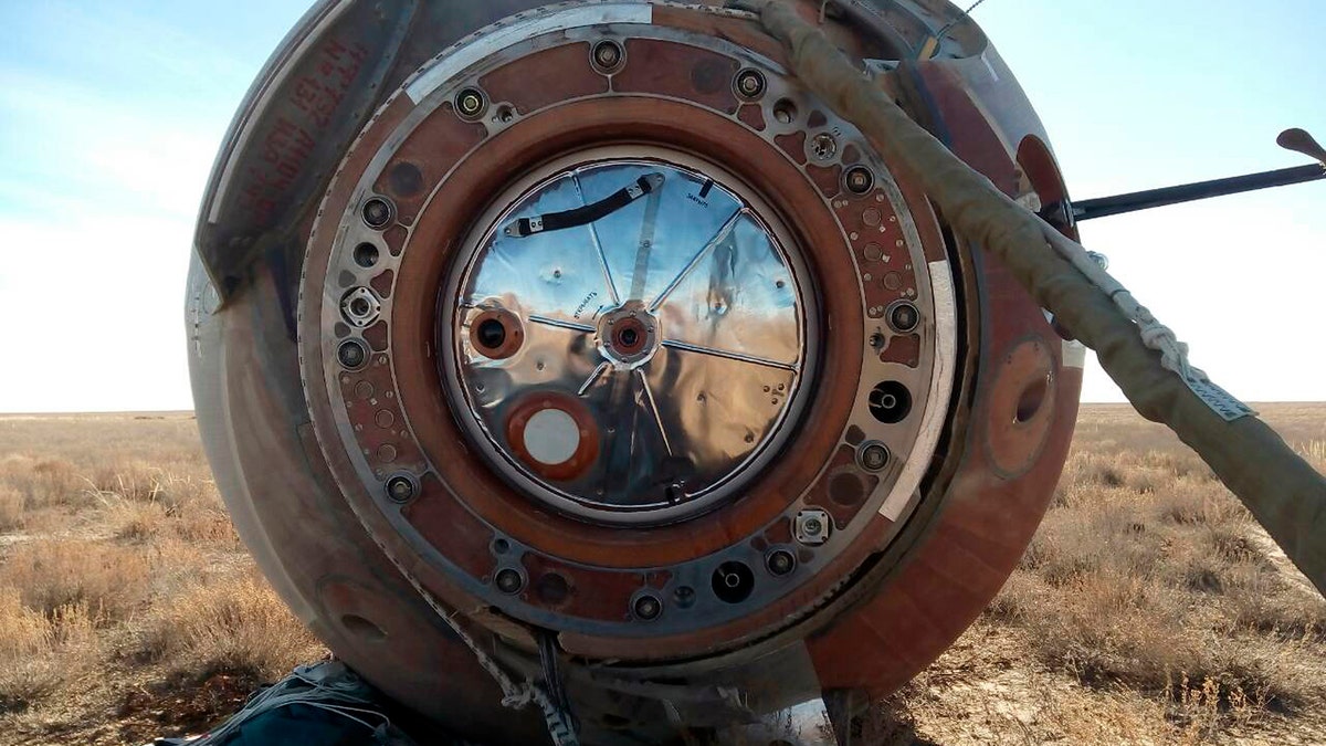In this photo provided by Russian Defense Ministry Press Service, the Soyuz MS-10 space capsule lays in a field after an emergency landing near Dzhezkazgan, about 450 kilometers (280 miles) northeast of Baikonur, Kazakhstan, Thursday, Oct. 11, 2018. NASA astronaut Nick Hague and Roscosmos' Alexei Ovchinin lifted off as scheduled at 2:40 p.m. (0840 GMT; 4:40 a.m. EDT) Thursday from the Russian-leased Baikonur cosmodrome in Kazakhstan, but their Soyuz booster rocket failed about two minutes after the launch.