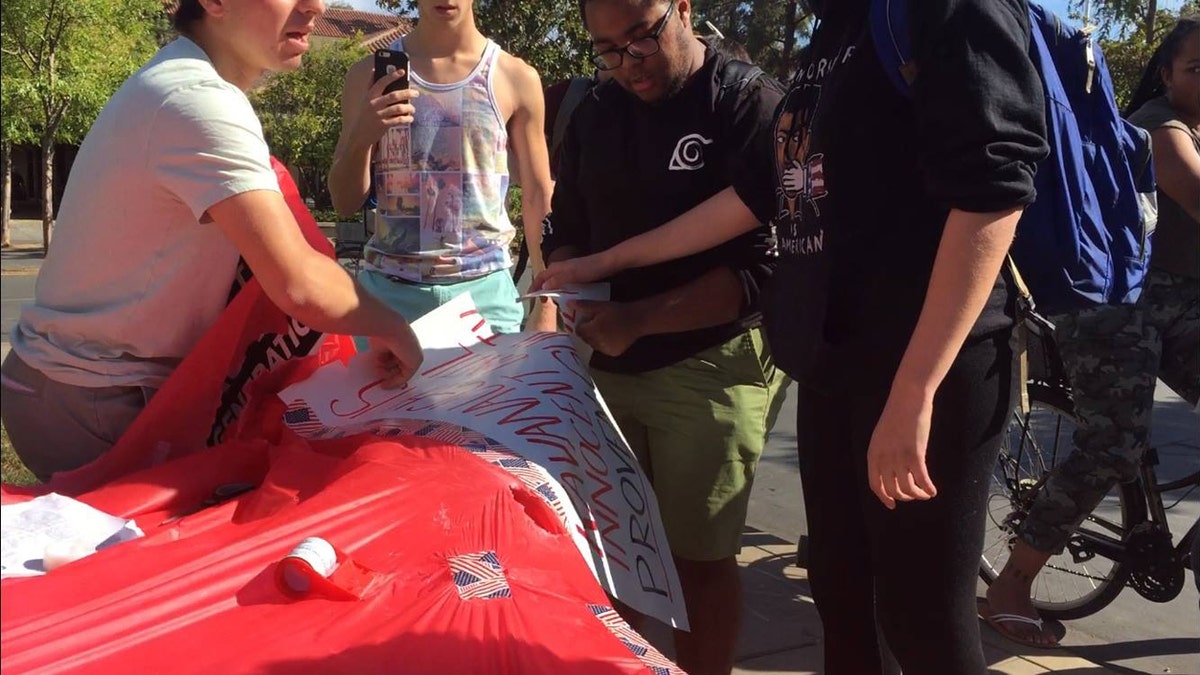 Several students ripped up signs and one was arrested on battery charges during a pro-Kavanaugh event Tuesday.