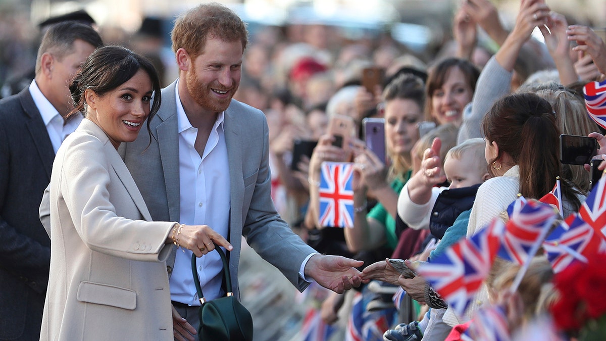 Britain's Prince Harry and Meghan, the Duchess of Sussex greet well wishers duringwell-wishers to Chichester, south east England, Wednesday Oct. 3, 2018. The Duke and Duchess of Sussex made their first joint official visit to Sussex.
