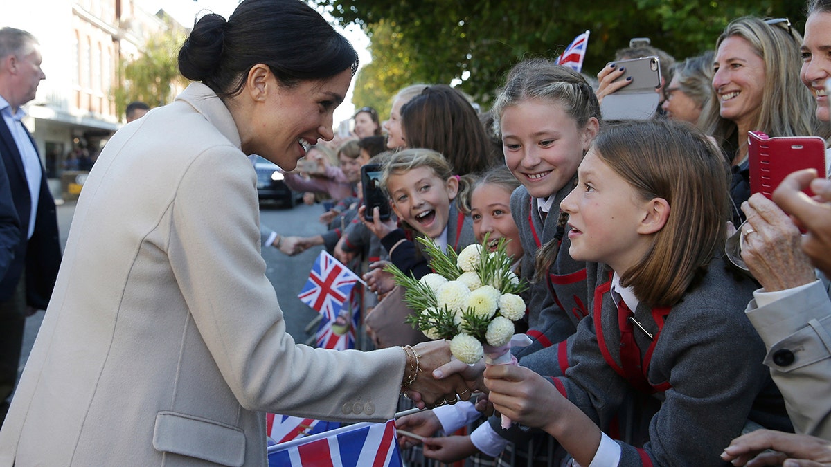 Britain's Meghan, the Duchess of Sussex greets well wishers as she and Prince Harry visit Chichester, south east England, Wednesday Oct. 3, 2018. The Duke and Duchess of Sussex made their first joint official visit to Sussex.