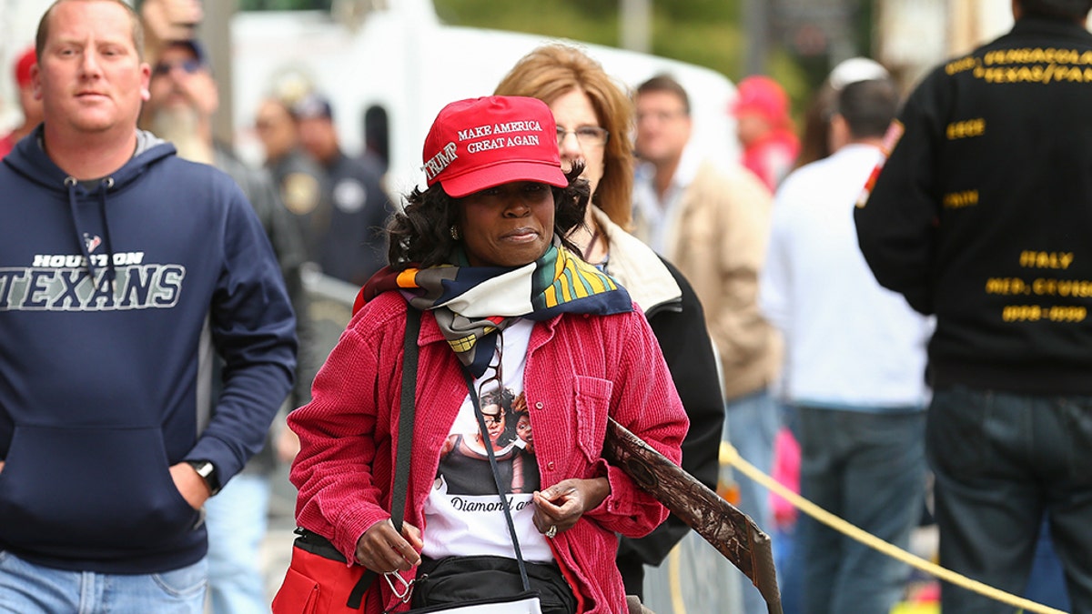 People arrive before a scheduled President Trump rally for Sen. Ted Cruz at the Toyota Center on Monday in Houston. (Godofredo A. Vasquez/Houston Chronicle via AP)