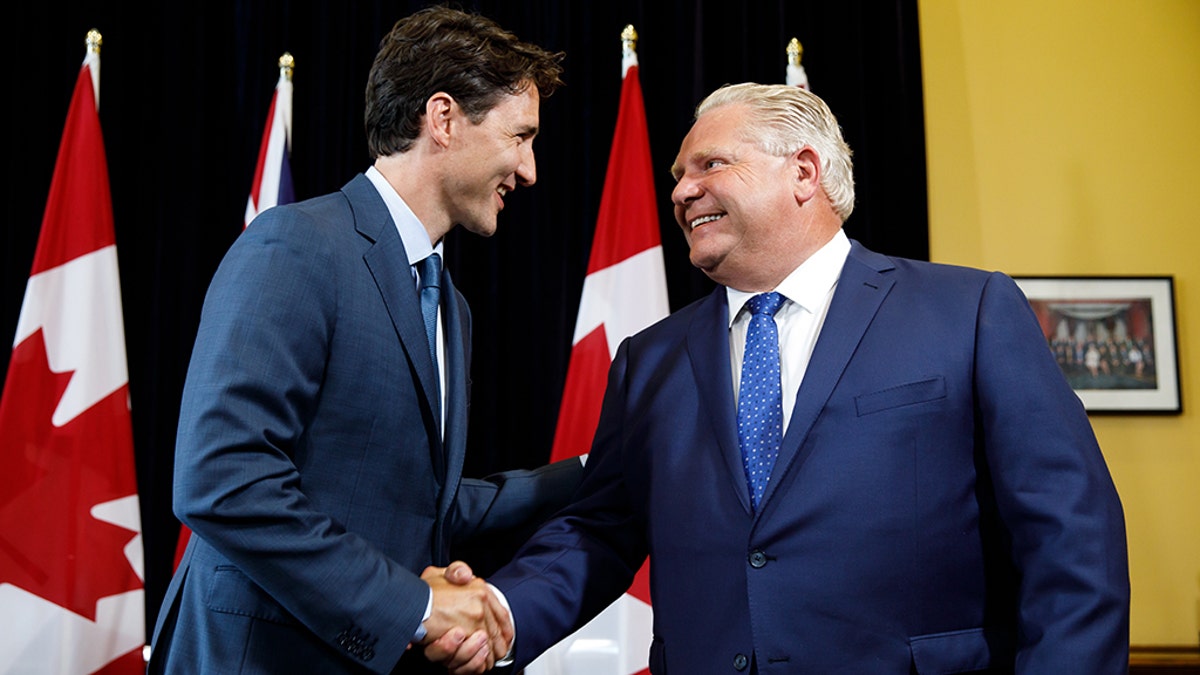 Civil for now: Prime Minister Trudeau meets with Premier Doug Ford in Toronto earlier this year; they have been at loggerheads over Trudeau's carbon tax
