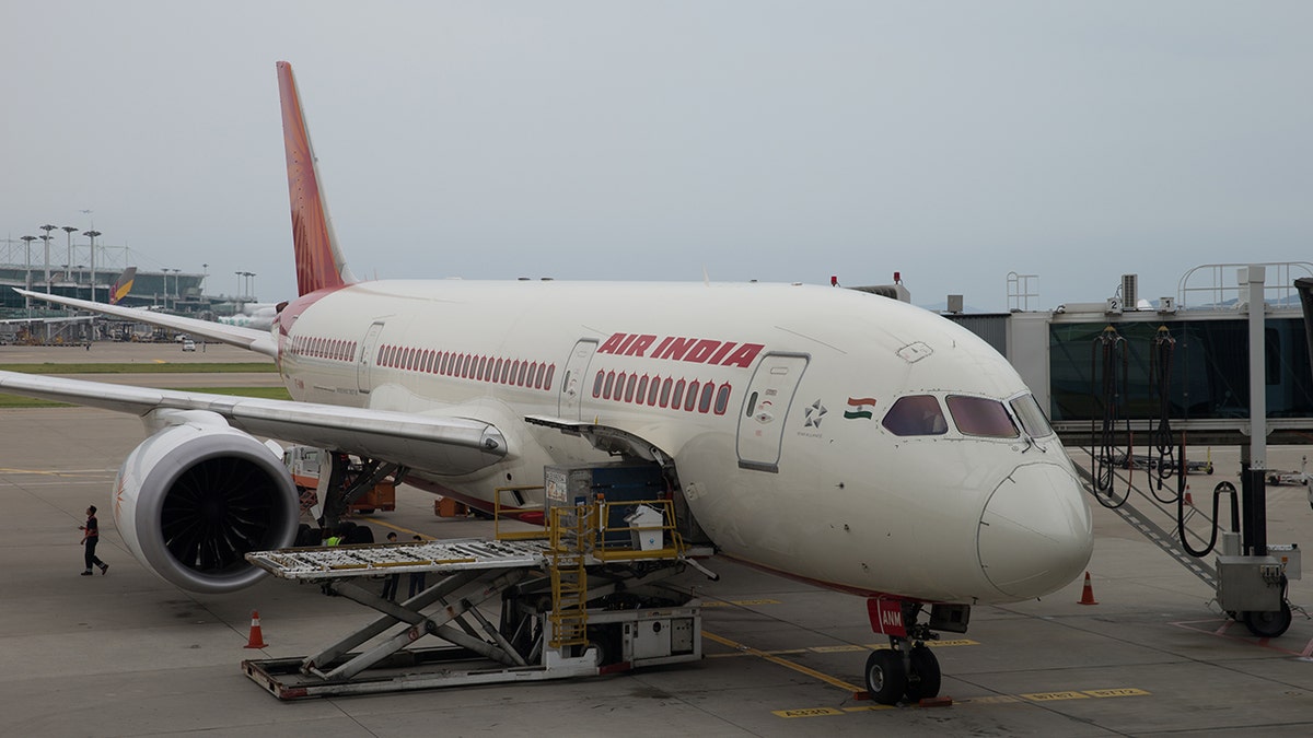 An Air India flight attendant sustained multiple injuries after falling out of an airplane as she prepared for boarding.