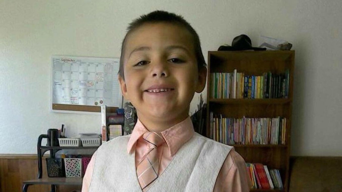 Anthony Avalos smiles in a tie and vest